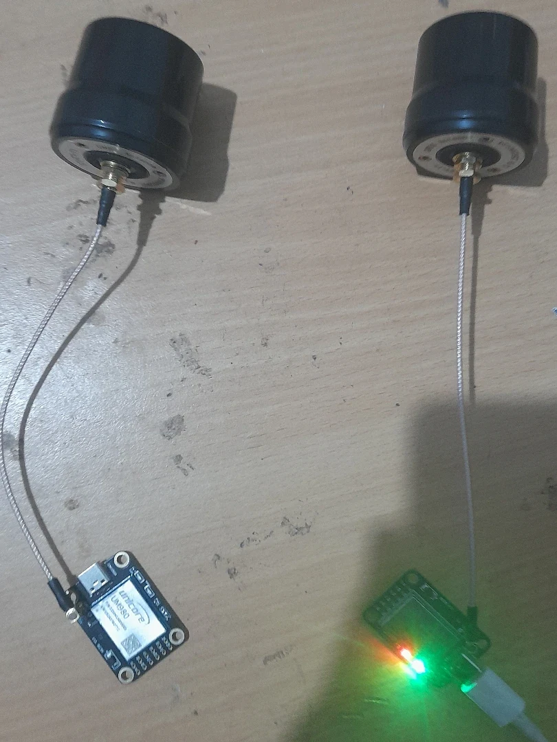 Two shaft components connected to small circuit boards on a workbench