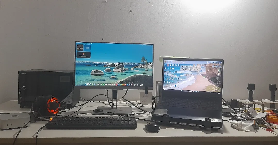 A dual-screen creative workspace with keyboard and computer